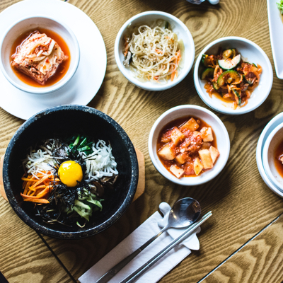 Korean bimbimbap with small appetizers surrounding it